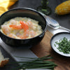 Sweetcorn & Prawn Chowder in a bowl topped with prawns and chives