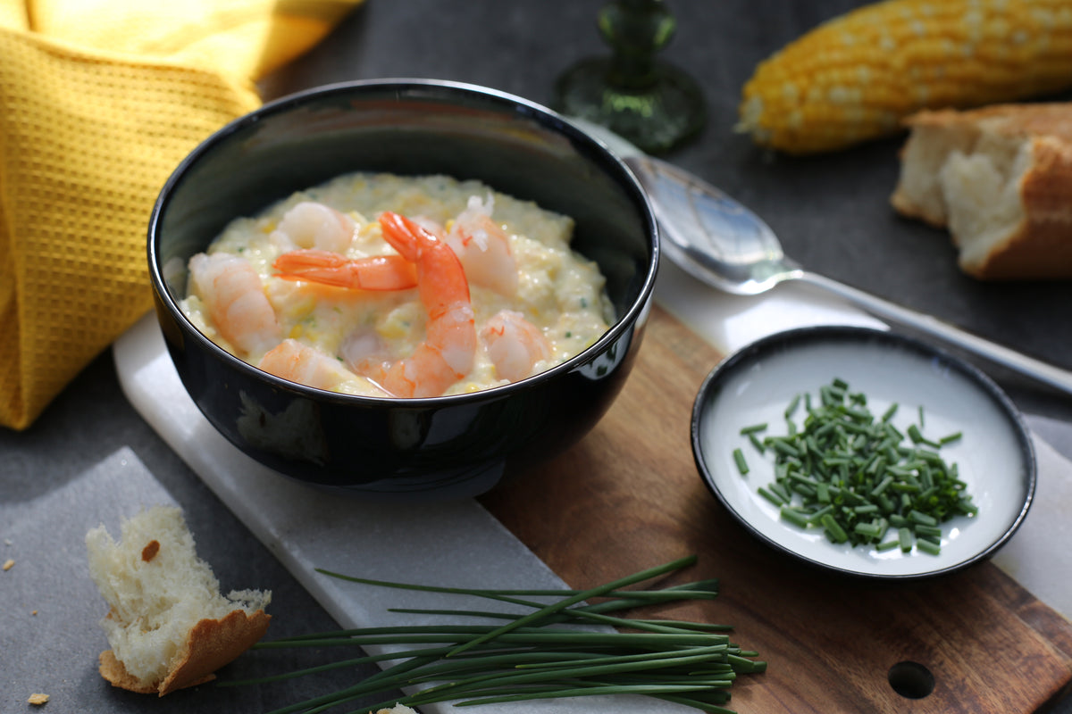 Sweetcorn & Prawn Chowder in a bowl topped with prawns and chives