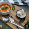 Tomato & Basil Soup with a swirl of cream, served with crusty bread